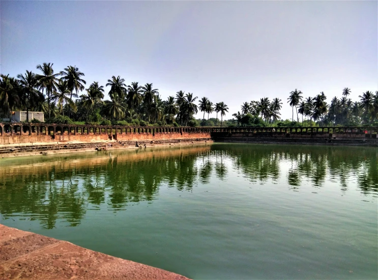 a body of water with a fenced area in the middle