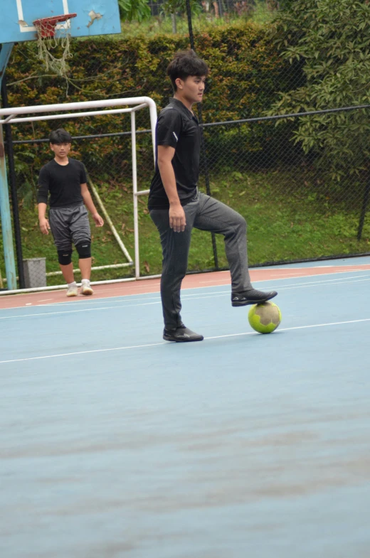 two boys are playing a game of soccer