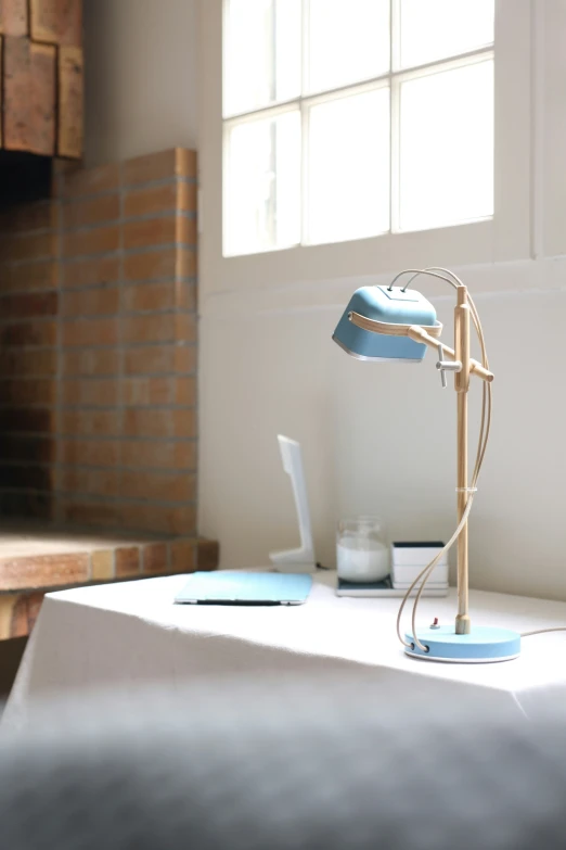 an iron lamp on a table with a laptop on it