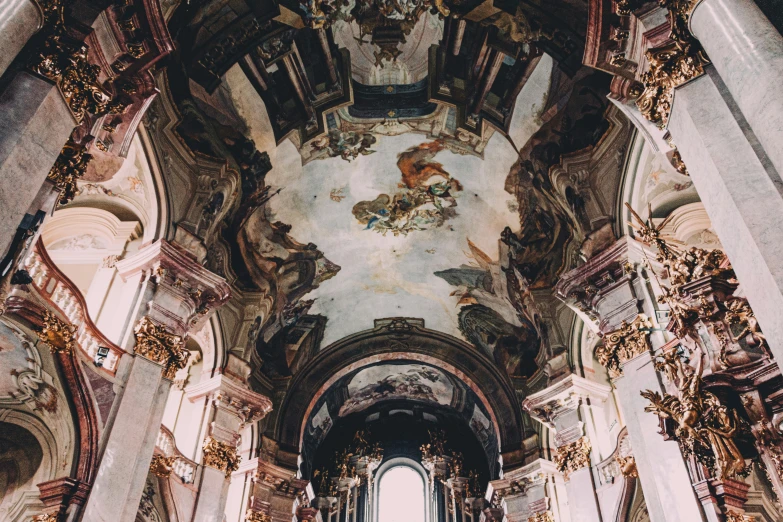 the interior of an empty cathedral with painted ceilings