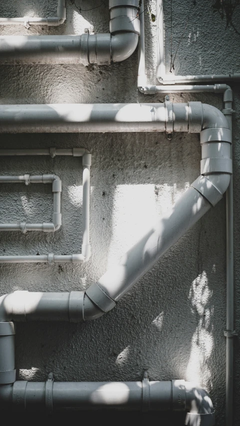 a gray industrial background with pipes and piping