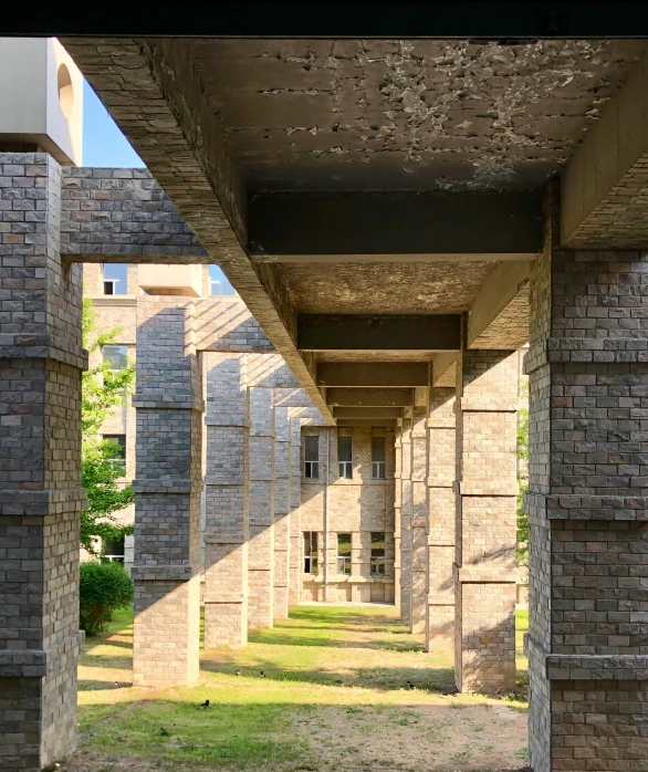 an architecturally designed brick walkway runs through a park