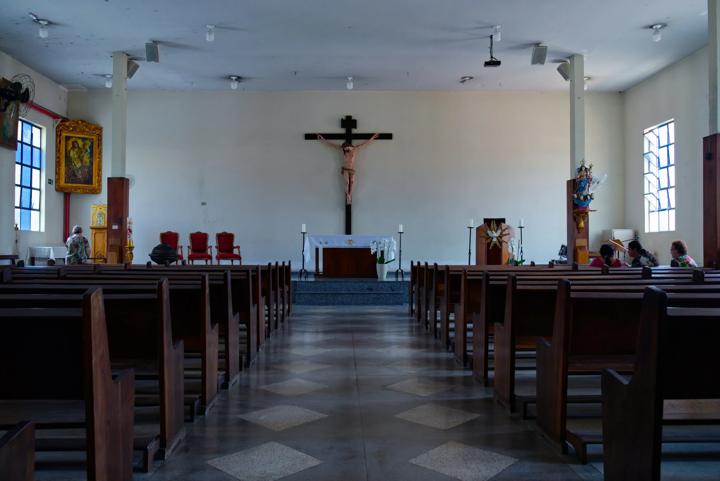 the inside of an old church with pews and a cross