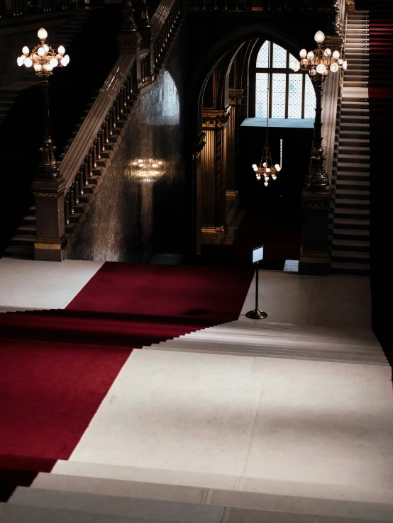 a room with some red carpet and stairs