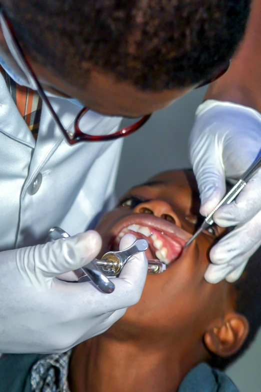 the young man is taking an examination on his patient's teeth