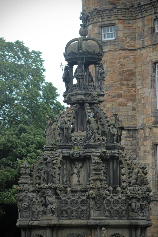 the tall clock tower has a very large clock at the top