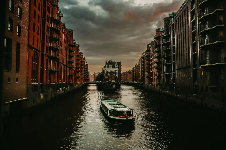 two boats are on a canal between some buildings