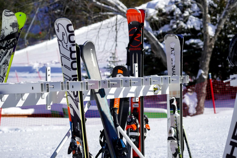 three snow skis and poles are positioned next to each other