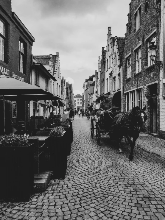 people on a cobble stone road walking down the street