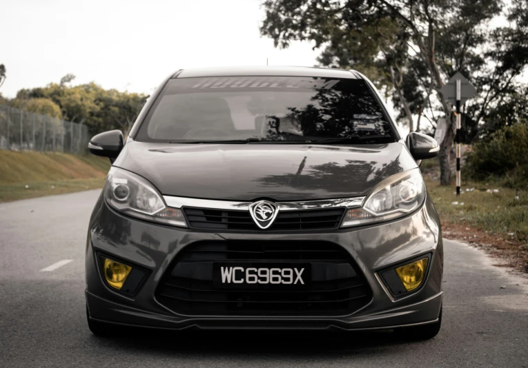 the front view of a car with lights on in the street