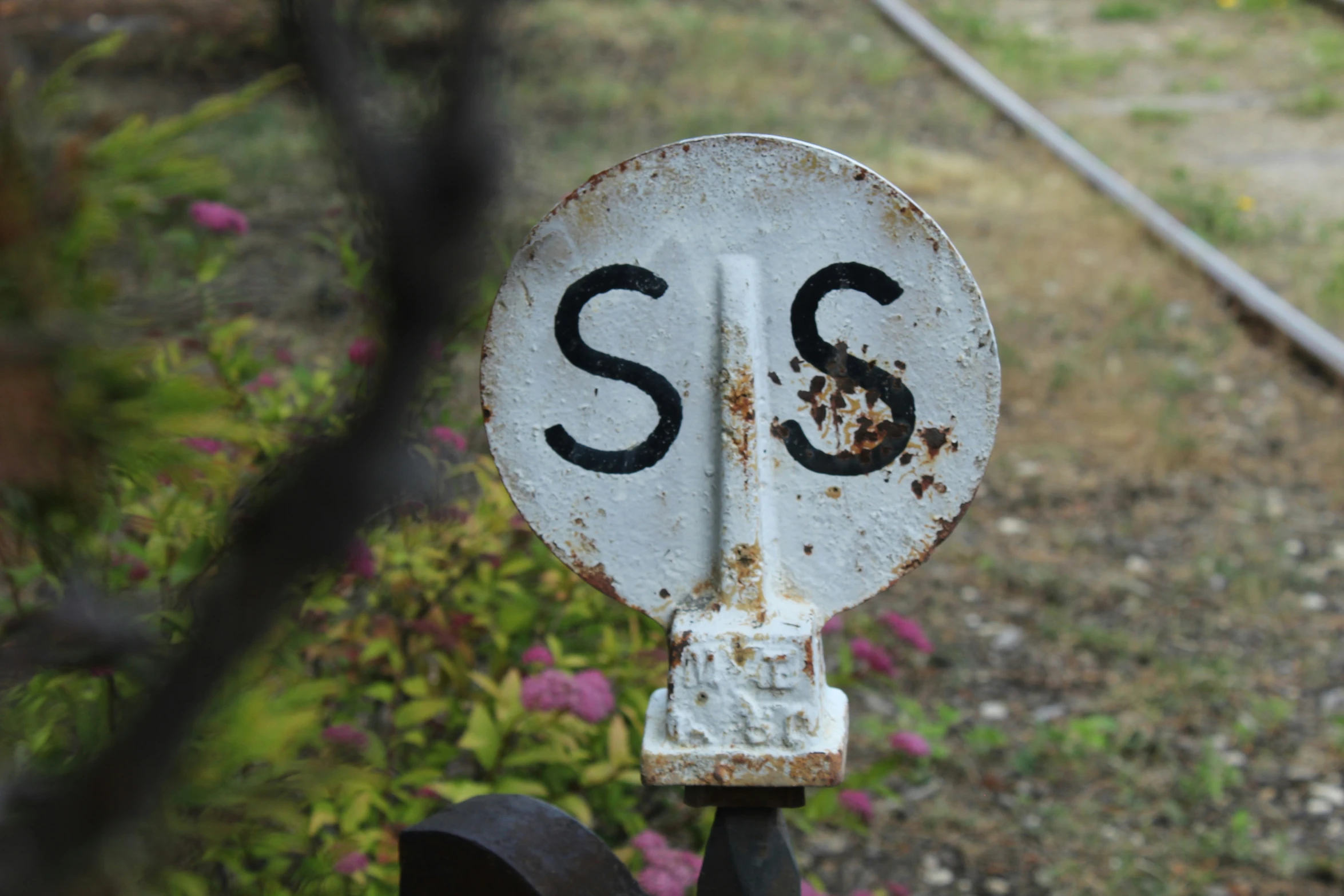 there is a rusted road sign on the post