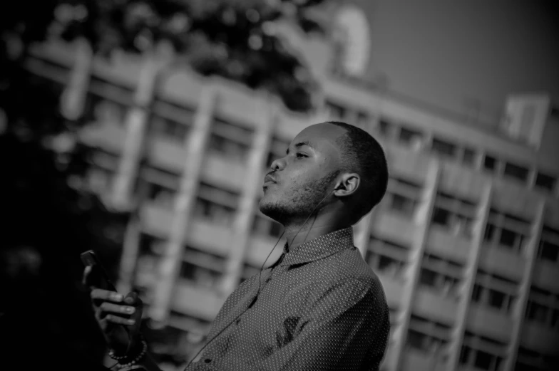 the man is in front of some buildings