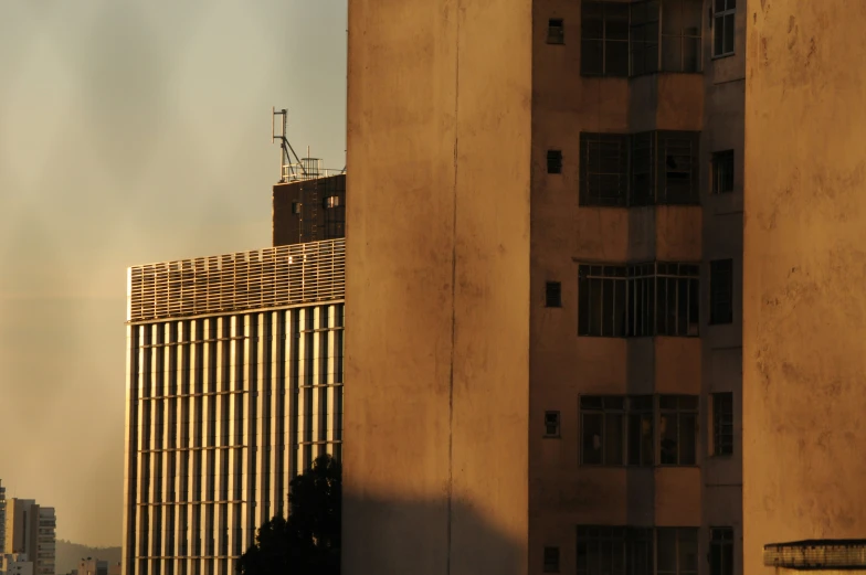 tall buildings sit near one another with a sky in the background