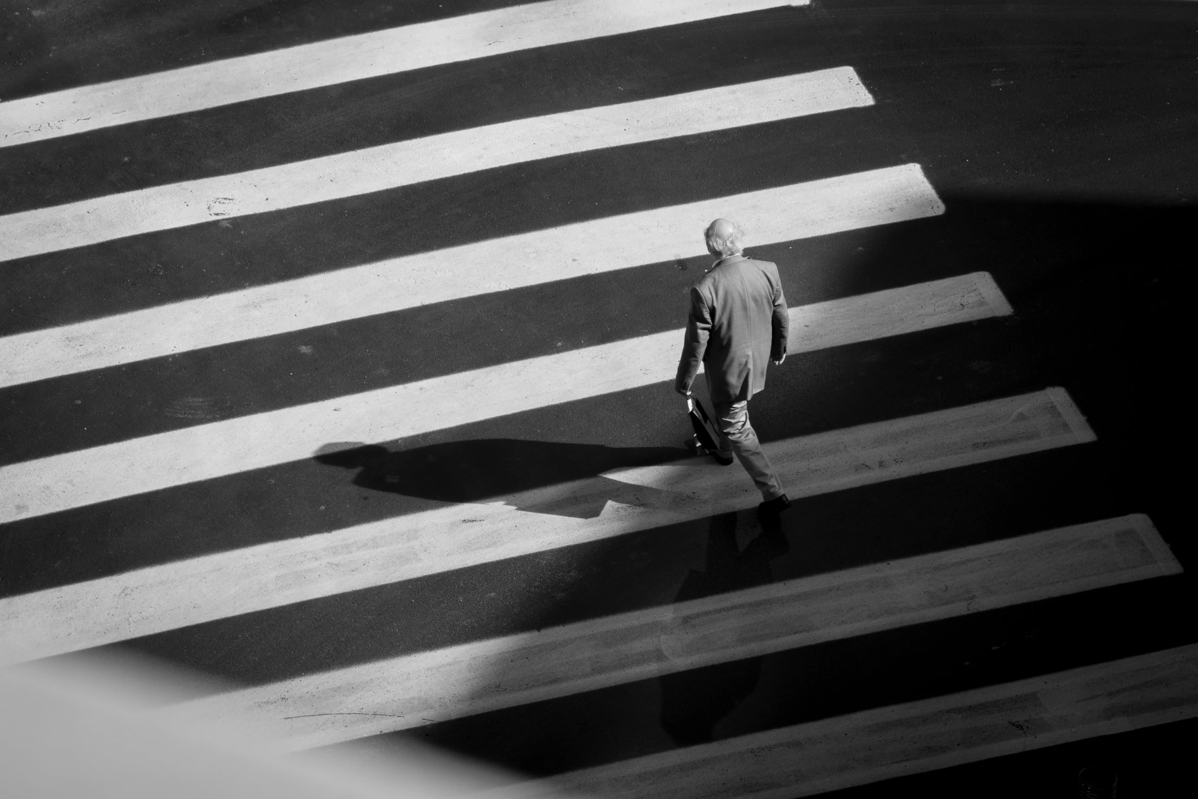 a man is walking down a road in the middle of the night