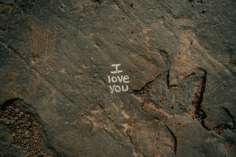 the chalk written i love stary is placed in the rock