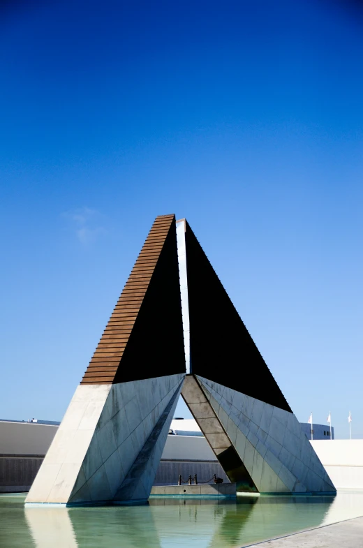 the front of a building with black triangles over it