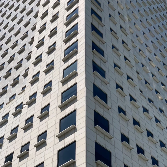 tall building, with small windows and a triangular design