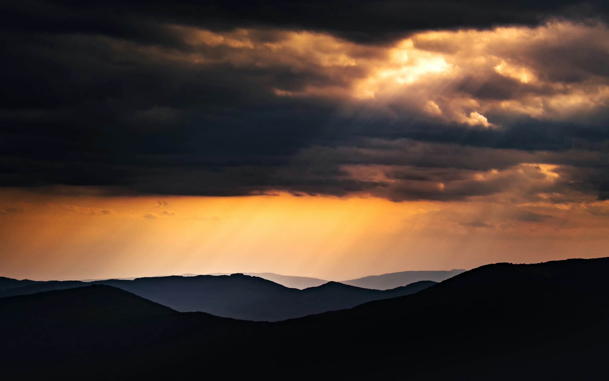 the sky and ground is dark as it covers a few hills