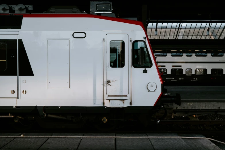 a passenger train sitting at a station, with no passengers