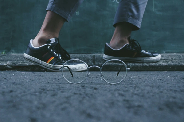 a pair of shoes is shown with circular glasses around them