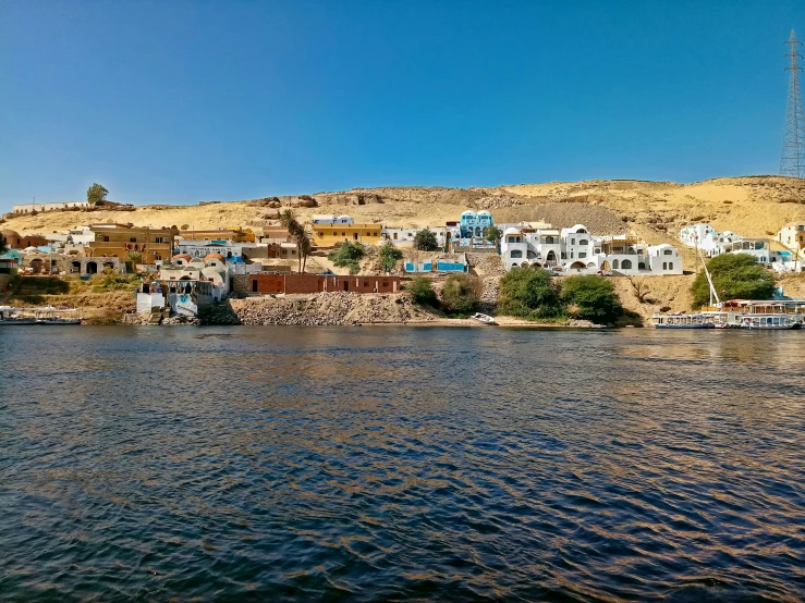 boats floating down a river near the shore