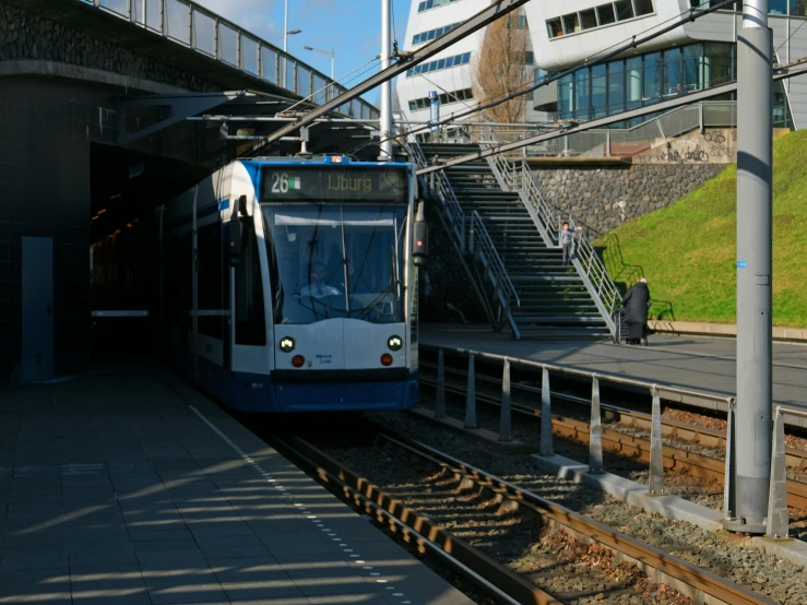 a train on the tracks is parked at the platform