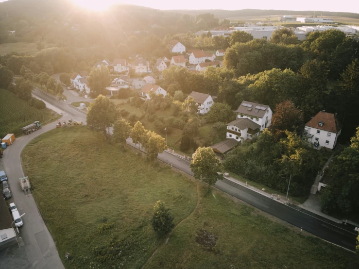 a small village next to a road in a field