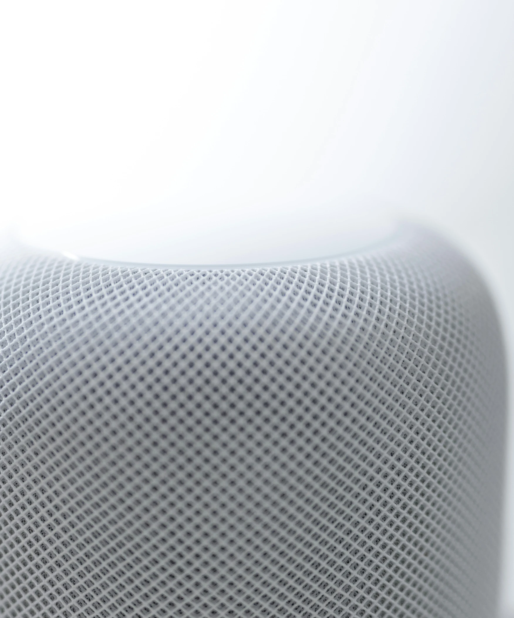 an apple phone is sitting on top of an apple speaker