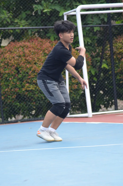 a young man is swinging at a ball