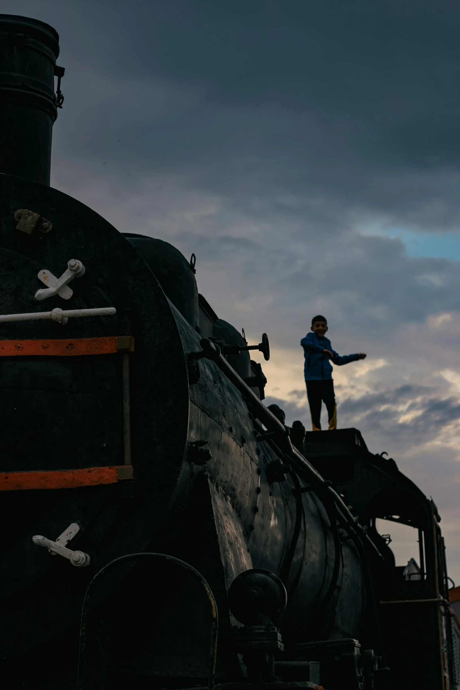 a person on top of a locomotive that has skulls on it