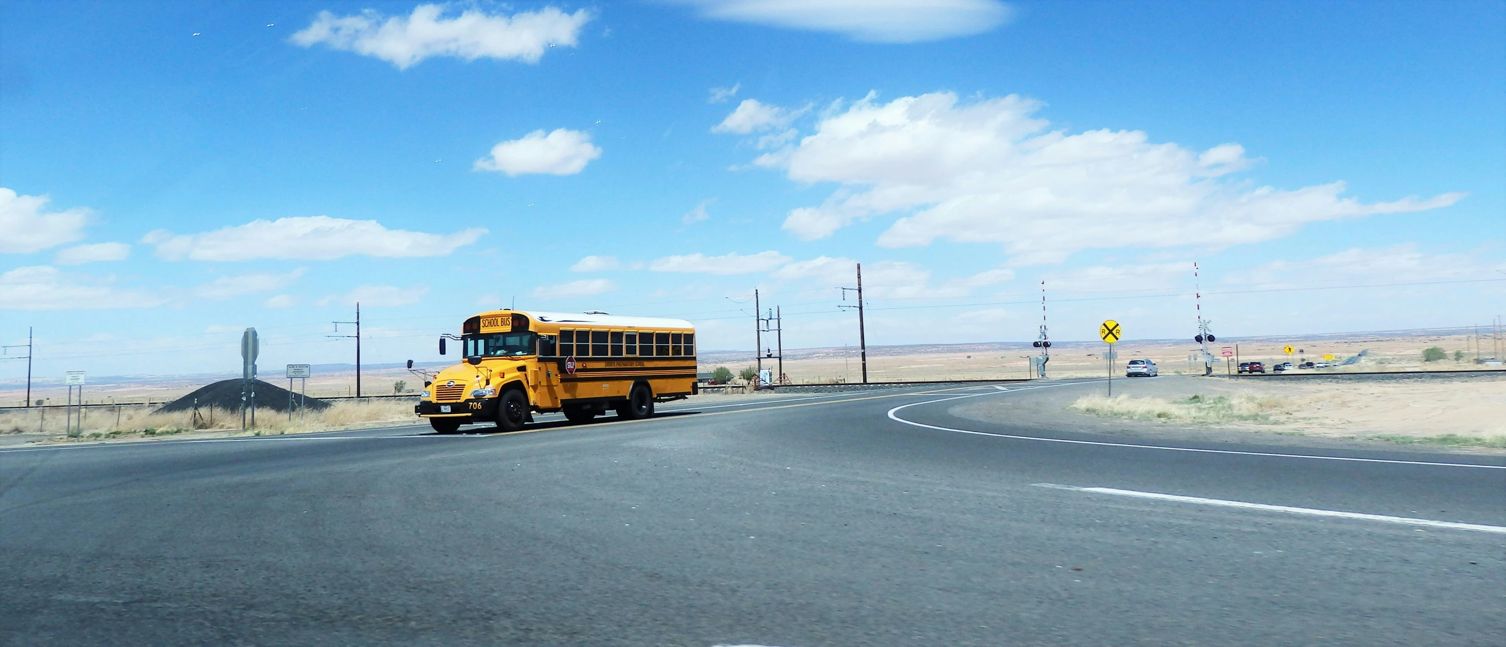 a bus is parked in a curve along the side of the road