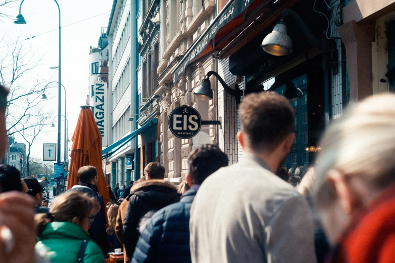 a crowd of people walking down a city street