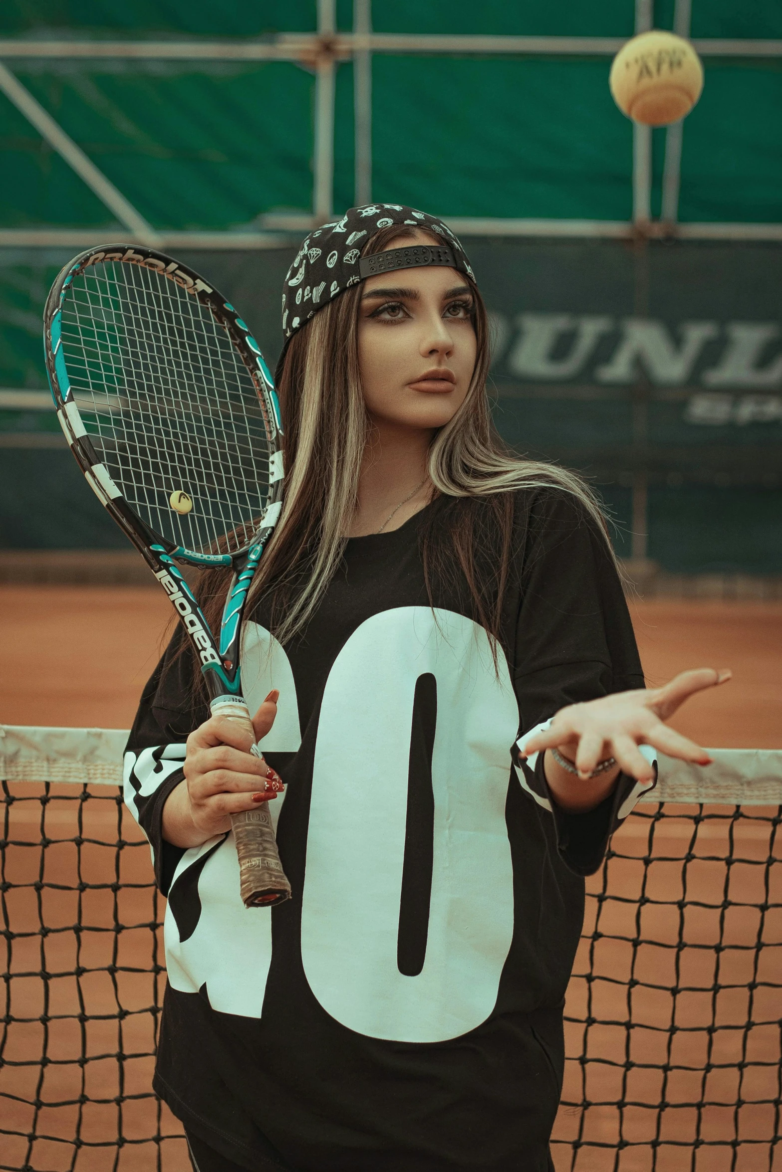 the woman is standing on the tennis court holding her racket