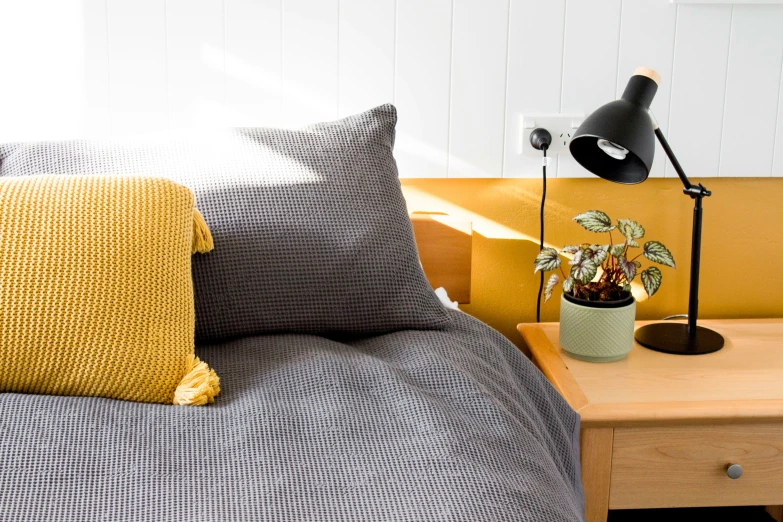 the yellow bedding in this modern bedroom is stylish and whimsical