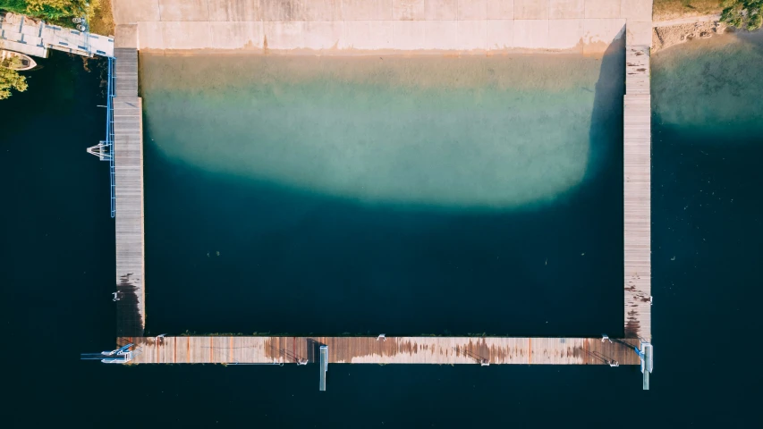 a body of water with docks surrounding it and trees