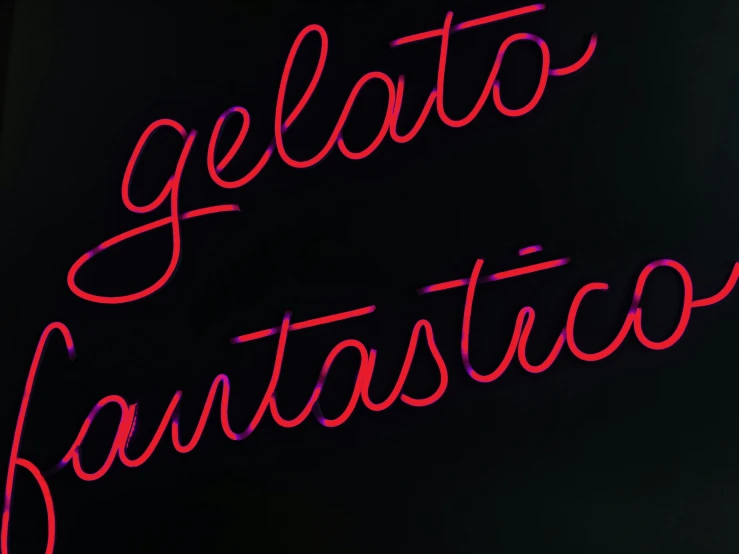 the word gelato fantastic written in red neon lights