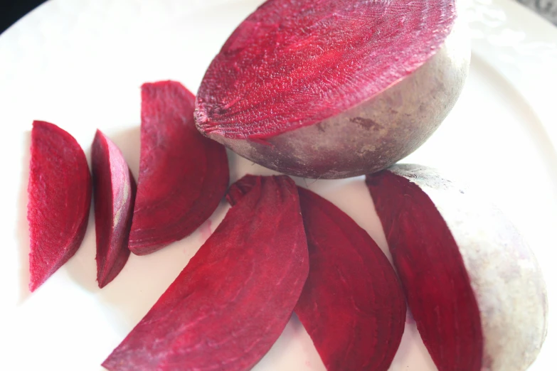 a whole radishes cut up on a plate