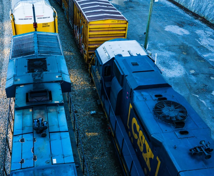 two large trains are parked side by side