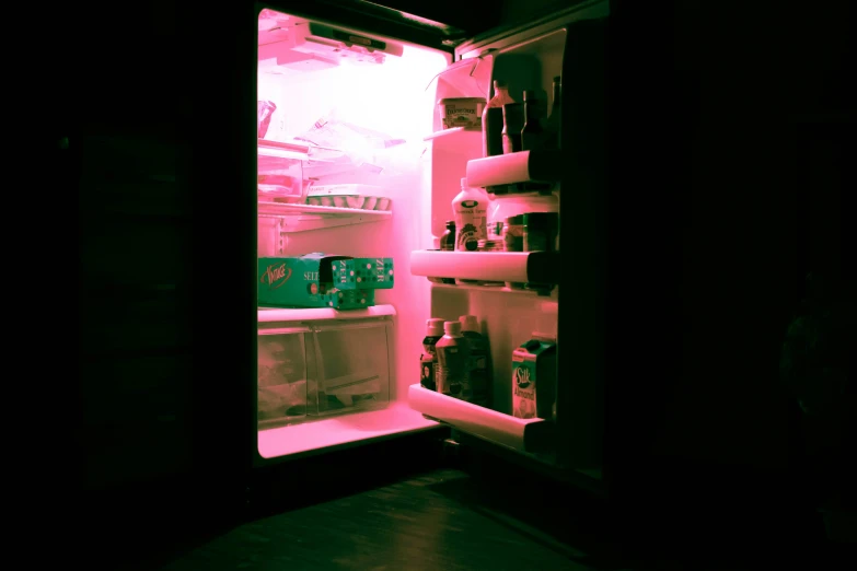 the light shines on the refrigerator door revealing what's inside