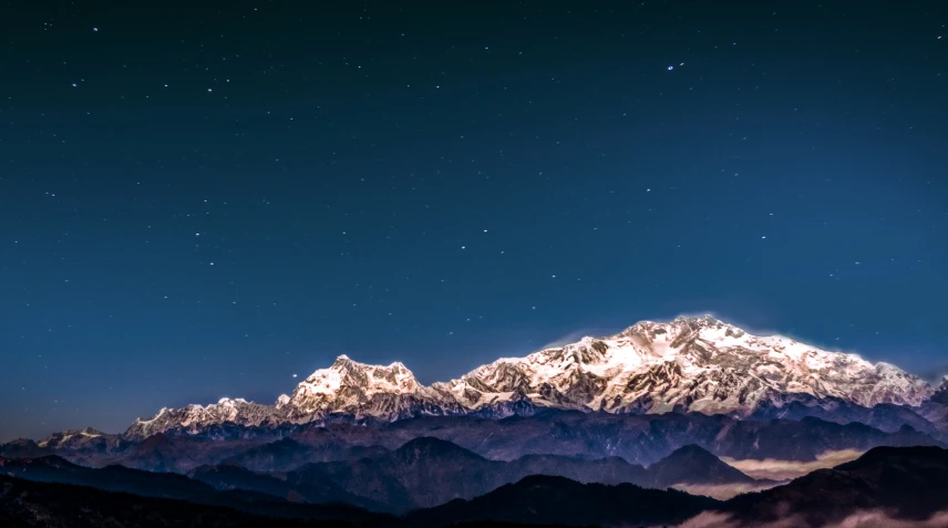 a nighttime view of the majestic snow - capped peaks