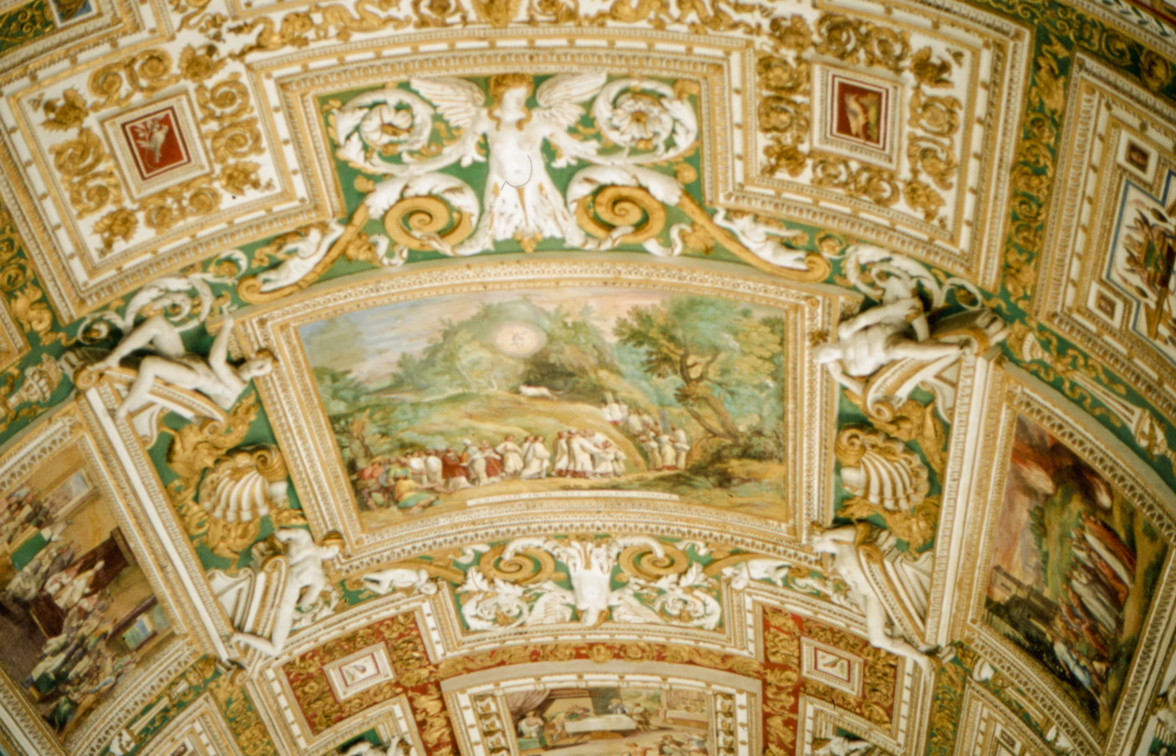 an ornate ceiling has elaborate paintings and sculptures