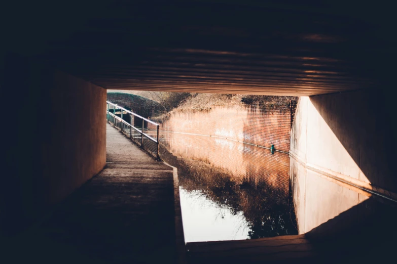 light shines brightly through the opening in this tunnel