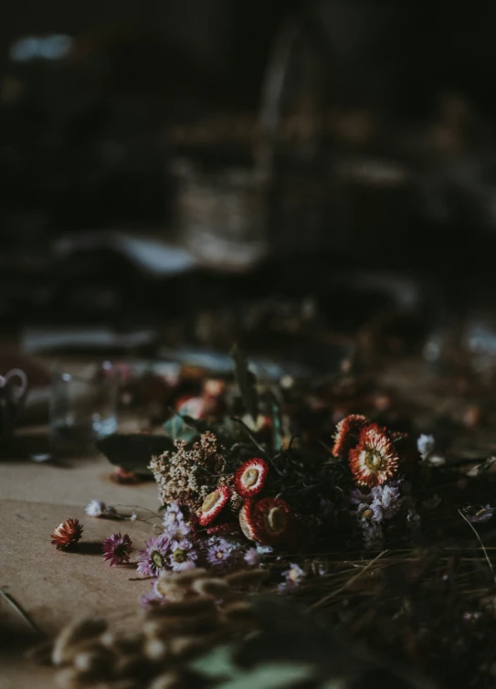 a pile of dead flowers and rocks are lying on a floor