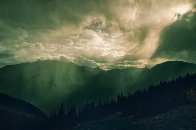 a picture of a cloudy sky that appears to be over hills