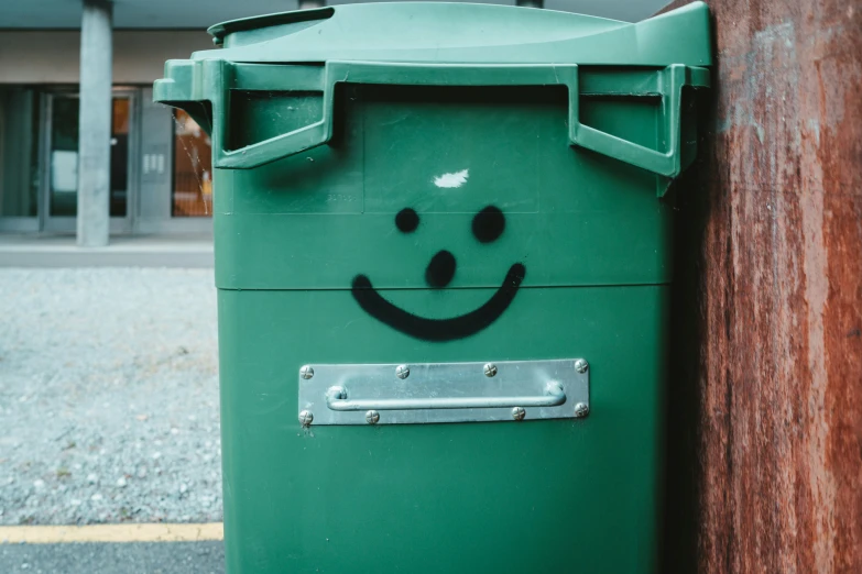 an open trash can with graffiti on it