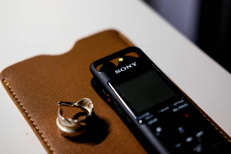 a cell phone sitting on a leather case