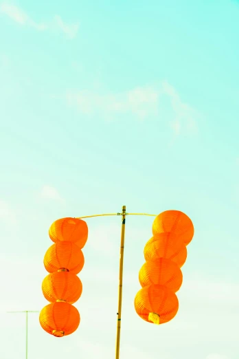 a number of light posts with several orange lights on them