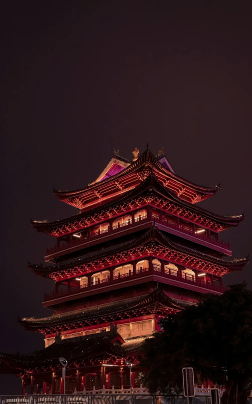 a lit up tower sits in the evening