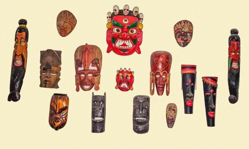 a lot of native indian masks laying out on a white background