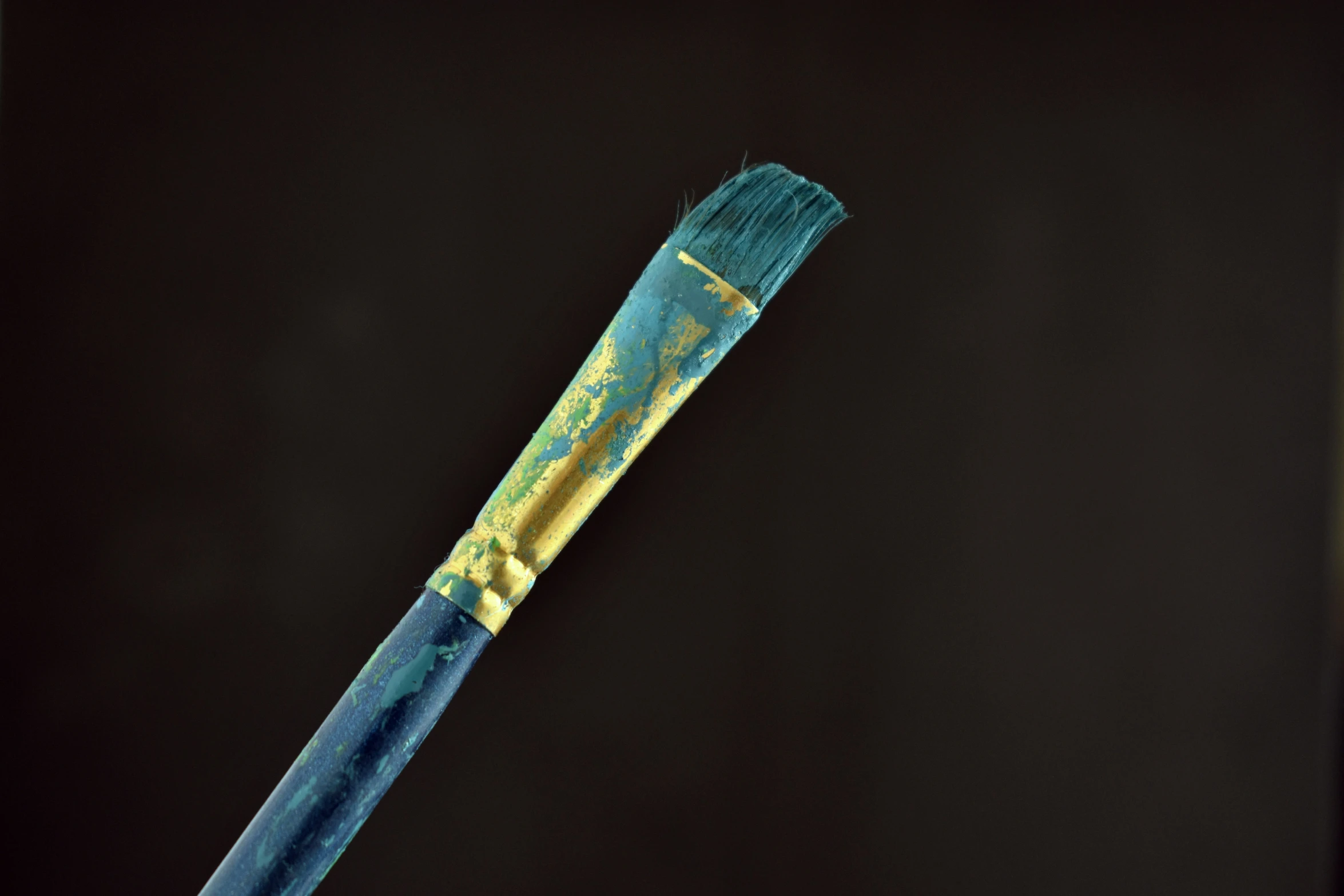 a blue and yellow object sitting in a cup